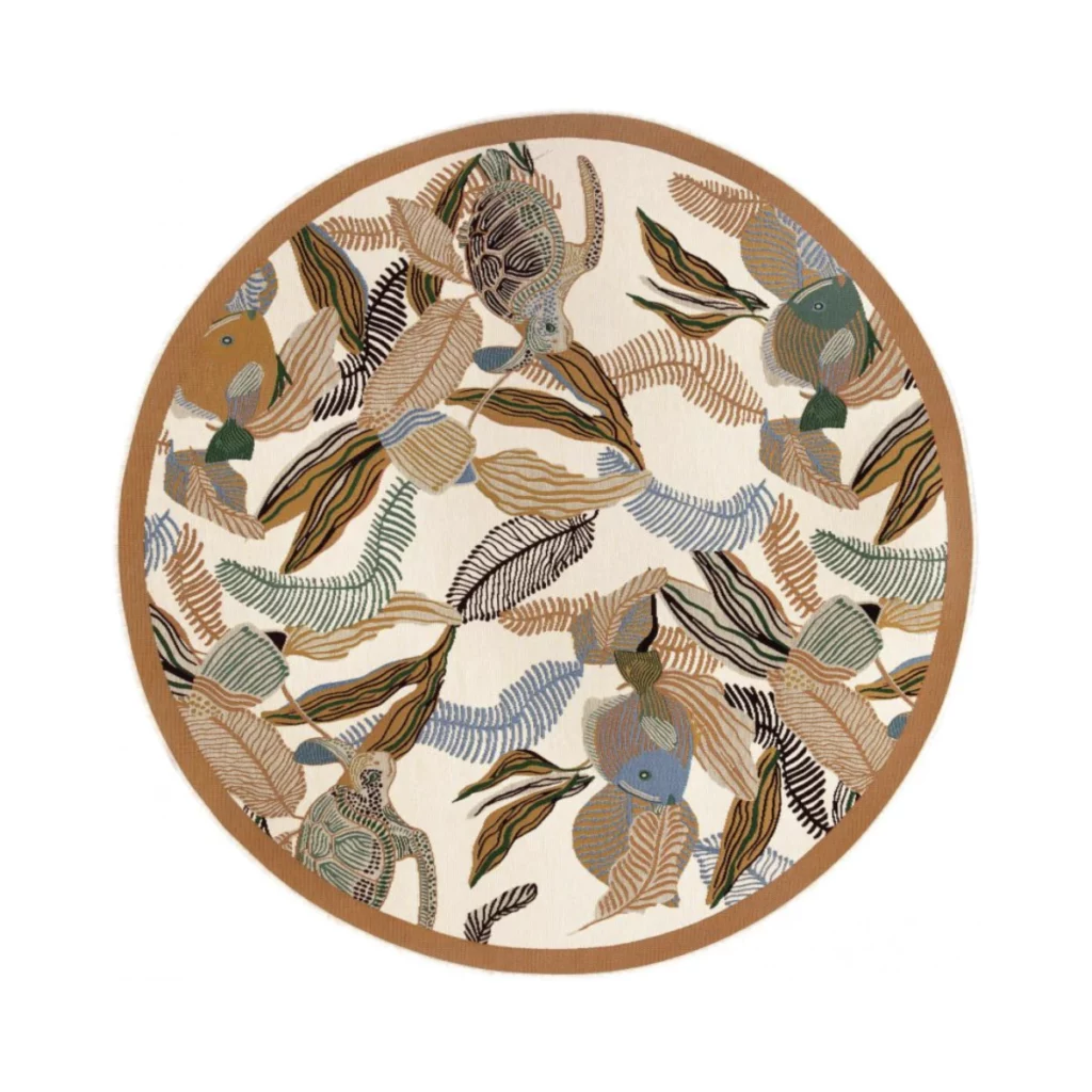DORI Outdoor Rug 160 cm round – Vintelio, featuring a vibrant tropical design with abstract leaves, fish, and turtle motifs in earthy tones of beige, green, blue, and brown, perfect for adding a stylish and nature-inspired accent to outdoor or indoor spaces.